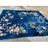 A Large Wool Carpet, blue ground, flower and prunus decoration, (some ware) 313cm x 264cm.