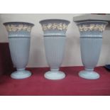 Three Blue Wedgwood Queensware Fluted Tall Vases, with vine to rim, 28cm high.