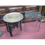 A Brass Charger, with cross supports, together with a metal occasional table decorated with