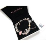 Pandora; A Modern Charm Bracelet, with assorted novelty sliding bead and other charms, in original