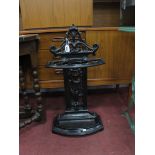 XIX Century Cast Iron Stick Stand, decorated with a cherub holding a basket, with a drip tray,with