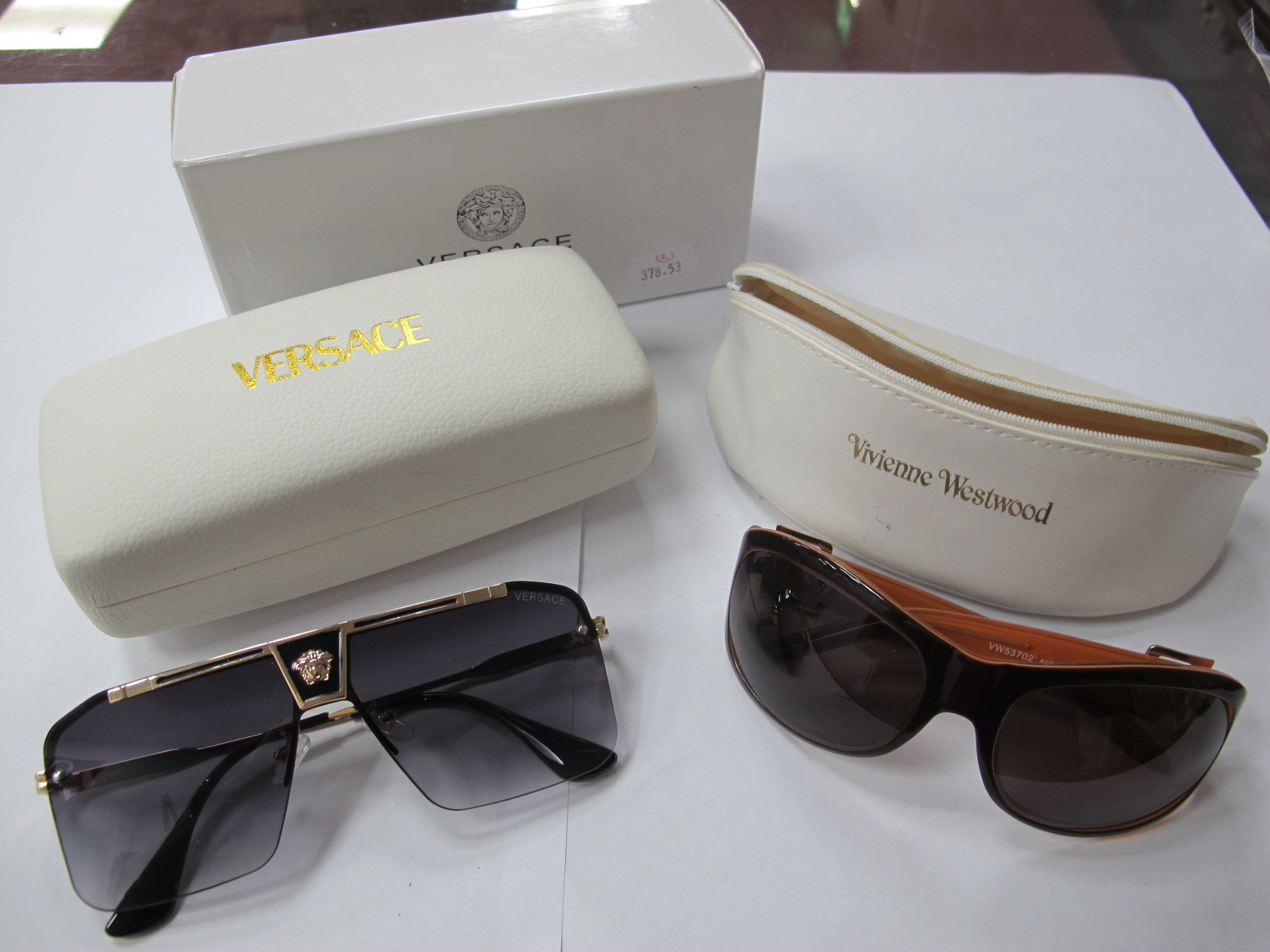 A Pair of Versace Sunglasses, cased and boxed; plus a pair of Vivienne Westwood sunglasses,