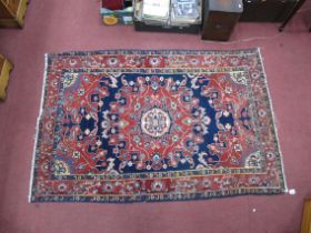 Persian Wool Rug, with a brown border, with deep red-blue centre with floral decoration, 128 x