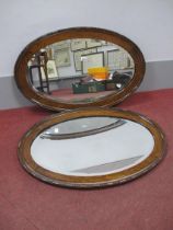 A Pair of 1920's Oak Oval Shaped Wall Mirrors, with bevelled glass.