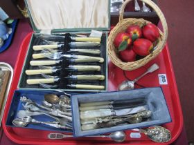 Silver Teaspoon, '830' elongated spoon, other cutlery, basket of faux fruit.