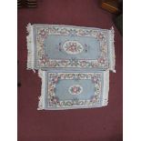 Two XX Century Wool Rugs, border with floral decoration. the largest 68 x 126cm, smallest 59 x