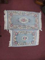 Two XX Century Wool Rugs, border with floral decoration. the largest 68 x 126cm, smallest 59 x