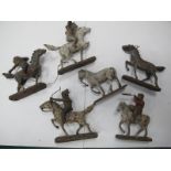 Cowboy and Indian Figures on Horseback, in composition, on oval wooden bases, six horses, four