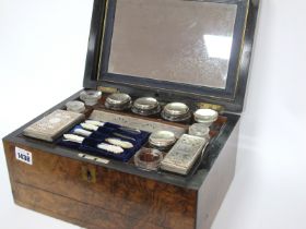 A Mid XIX Century Walnut Cased Travelling Ladies Toilet Case, the lid with central brass