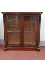 A XIX Century Bookcase, the top with scroll supports, glazed doors on plinth base, 145cm high, 142cm