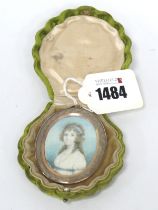 A Portrait Miniature of a Lady, wearing a white dress with blue sash, unsigned on paper, the