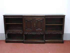 A XX Century Oak Breakfronted Bookcase, with central moulded front panelled doors and flanking