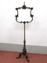 A XIX Century Rosewood Pole Screen, the shaped screen with 'C' scroll decoration, on a reeded column