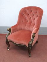 A Mid XIX Century Walnut Armchair, with upholstered button back, scroll arms and shaped apron on