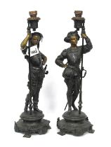 A Pair of Late XIX Century Speltre Figures, cast as Cavaliers, each holding a candle holder and