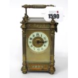 A French Brass Cased Late XIX Century Carriage Clock, with rounded side pillars and moulded