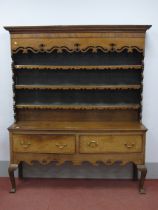 A Mid XVIII Century Oak Dresser, with mahogany crossbanding, the rack with a stepped cornice and