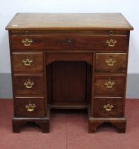 A Mid XVIII Century Mahogany Kneehole Desk, with brushing slide over a single long drawer, the