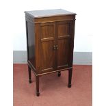 A 1950's Mahogany Music Cabinet, the top with moulded edge, twin panelled doors to internal