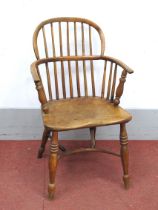 A XIX Century Ash and Elm Windsor Chair, with hooped back and rail supports, on turned legs united