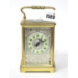 An Early XX Century Brass Cased Carriage Clock, of typical form, the silver engraved dial with cream