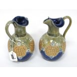 A Pair of Royal Doulton Stoneware Ewers, with frilled necks, the bodies with gilt scroll panels