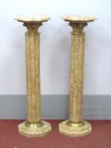 A Pair of Marble Columns, with octagonal tops with brass capitals, fluted shafts on stepped