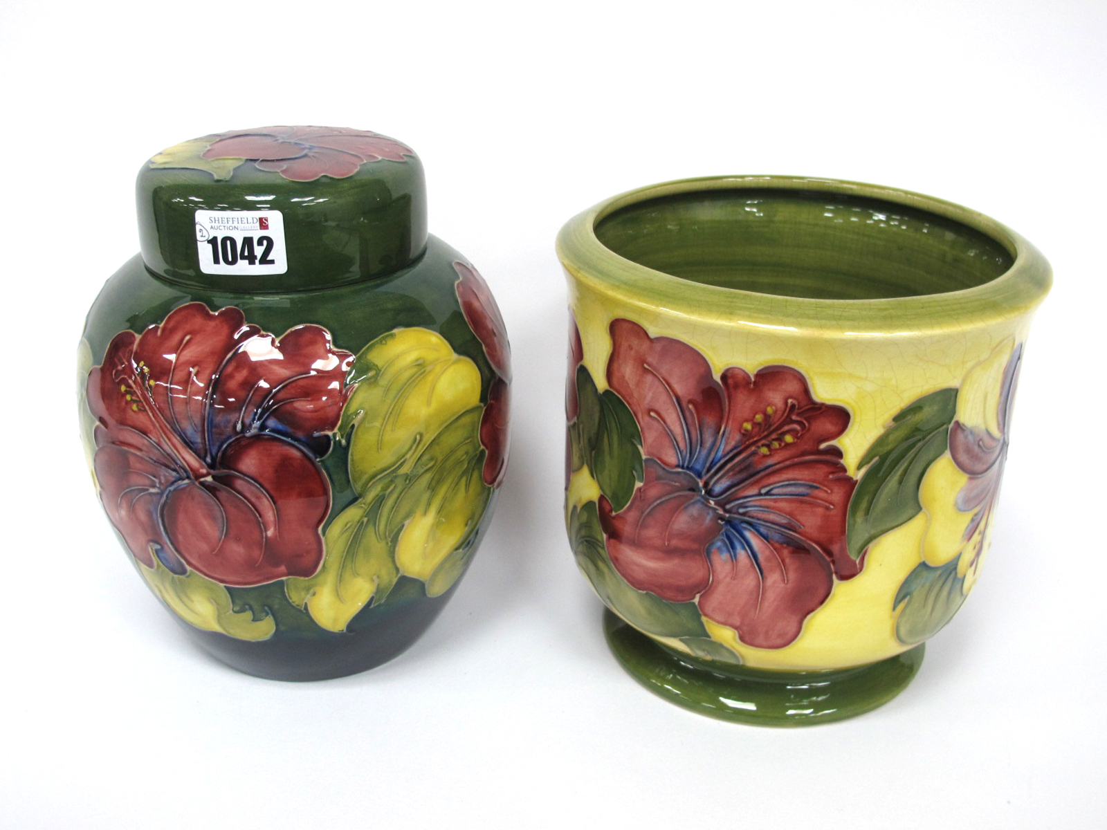 A Moorcroft Pottery Ginger Jar and Cover, of ovoid form, painted in the 'Hibiscus' pattern with
