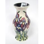 A Moorcroft Pottery Vase, of baluster form, painted with the 'Iris' pattern against an ivory ground,