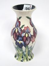 A Moorcroft Pottery Vase, of baluster form, painted with the 'Iris' pattern against an ivory ground,