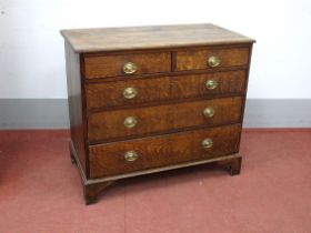 An Early XIX Century Oak Chest of Drawers, the top with a moulded edge over two short and three long
