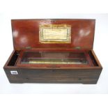 A Mid XIX Century Swiss Musical Box, the rosewood case inlaid with flowers, playing eight airs, with