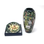 A Moorcroft Pottery Dish, painted with an Orchid design against a green ground, impressed and