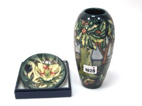 A Moorcroft Pottery Dish, painted with an Orchid design against a green ground, impressed and