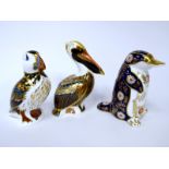 Three Royal Crown Derby Porcelain Paperweights; 'Brown Pelican', 'Platypus', and 'Puffin', all