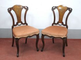 A Pair of Mid XIX Century Walnut Inlaid Chairs, the splats with a marquetry inlay of grotesque heads