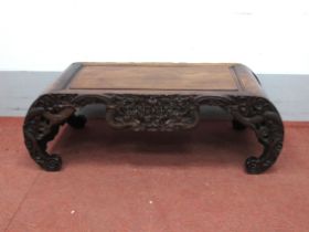 A Late XIX/Early XX Century Chinese Hardwood Opium Table, with panelled top and carved frieze,