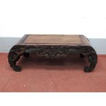 A Late XIX/Early XX Century Chinese Hardwood Opium Table, with panelled top and carved frieze,