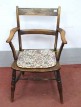 A XIX Century Ash and Elm Armchair, with rectangular top rail, central rail and shaped arms on