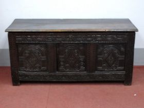 A XVII Century Joined Oak Coffer, with hinged top, the base with three lozenge carved panels and