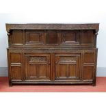 A Late XVII Century Joined Oak Court Cupboard, with carved frieze, panelled cupboard doors and