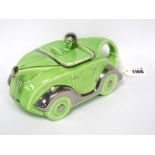 An Art Deco Pottery Teapot and Cover, modelled in the form of a car in lime green and silver, reg No