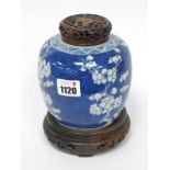 A Late XIX Century Chinese Porcelain Ginger Jar, with hardwood cover and stand, painted in blue with