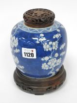 A Late XIX Century Chinese Porcelain Ginger Jar, with hardwood cover and stand, painted in blue with