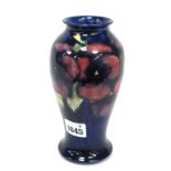 A Moorcroft Pottery Vase, of baluster form, painted in the 'Pansy' pattern with purple flowers