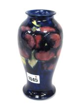 A Moorcroft Pottery Vase, of baluster form, painted in the 'Pansy' pattern with purple flowers