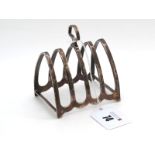 A Hallmarked Silver Five Bar Toast Rack, HCD, Birmingham 1931, of plain arch design with central