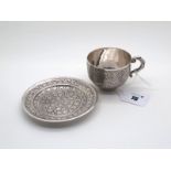 A Middle Eastern Cup and Saucer, the cup with allover foliate decoration and leaf scroll handle,