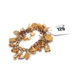 A 9ct Gold Curb Link Charm Bracelet, to heart shape padlock clasp, suspending numerous assorted