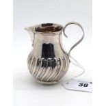 A Victorian Hallmarked Silver Cream Jug, GG, London 1886, semi gadrooned baluster form with plain